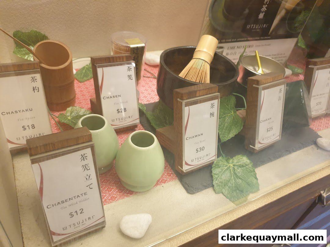 A display of traditional Japanese tea ceremony utensils with prices.