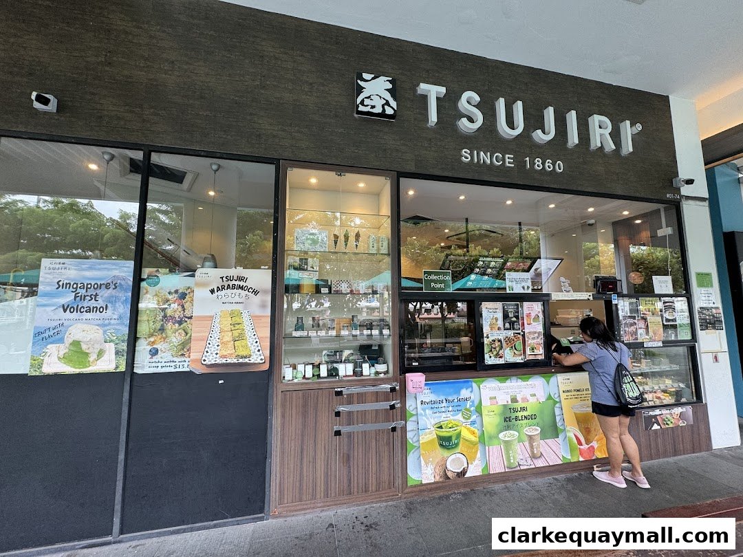 The exterior of TSUJIRI The Central Store, a dessert shop, with promotional posters and a customer ordering.