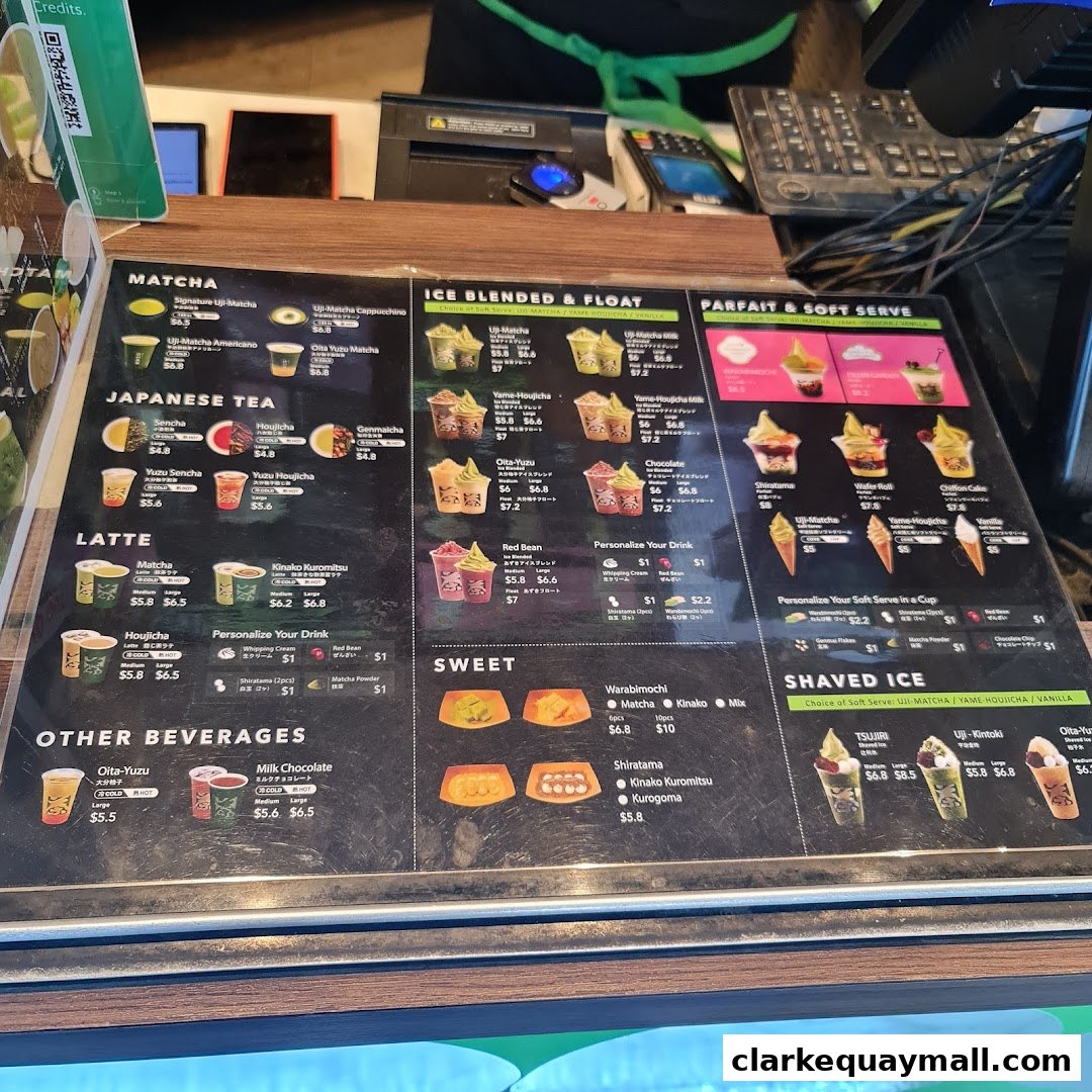 A menu board displaying various matcha, latte, and dessert items with prices.