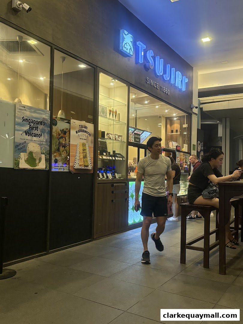 The TSUJIRI shop front with illuminated signage and display windows showcasing desserts.