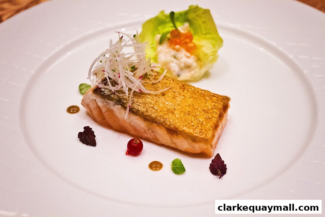 A beautifully plated salmon dish with crispy skin, shredded radish, and a side salad.