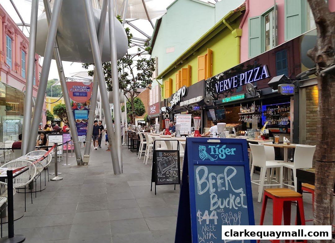 Verve Pizza Bar storefront with outdoor seating and a beer promotion sign.