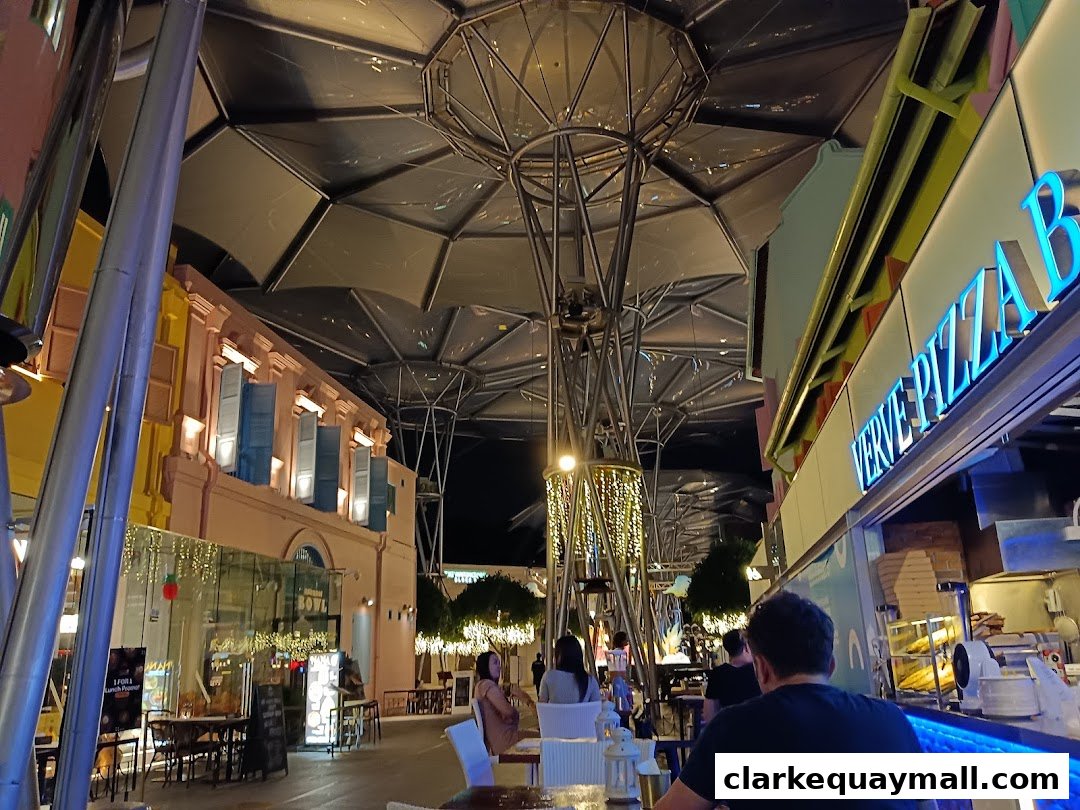 View of Verve Pizza Bar with outdoor seating and a distinctive canopy structure.