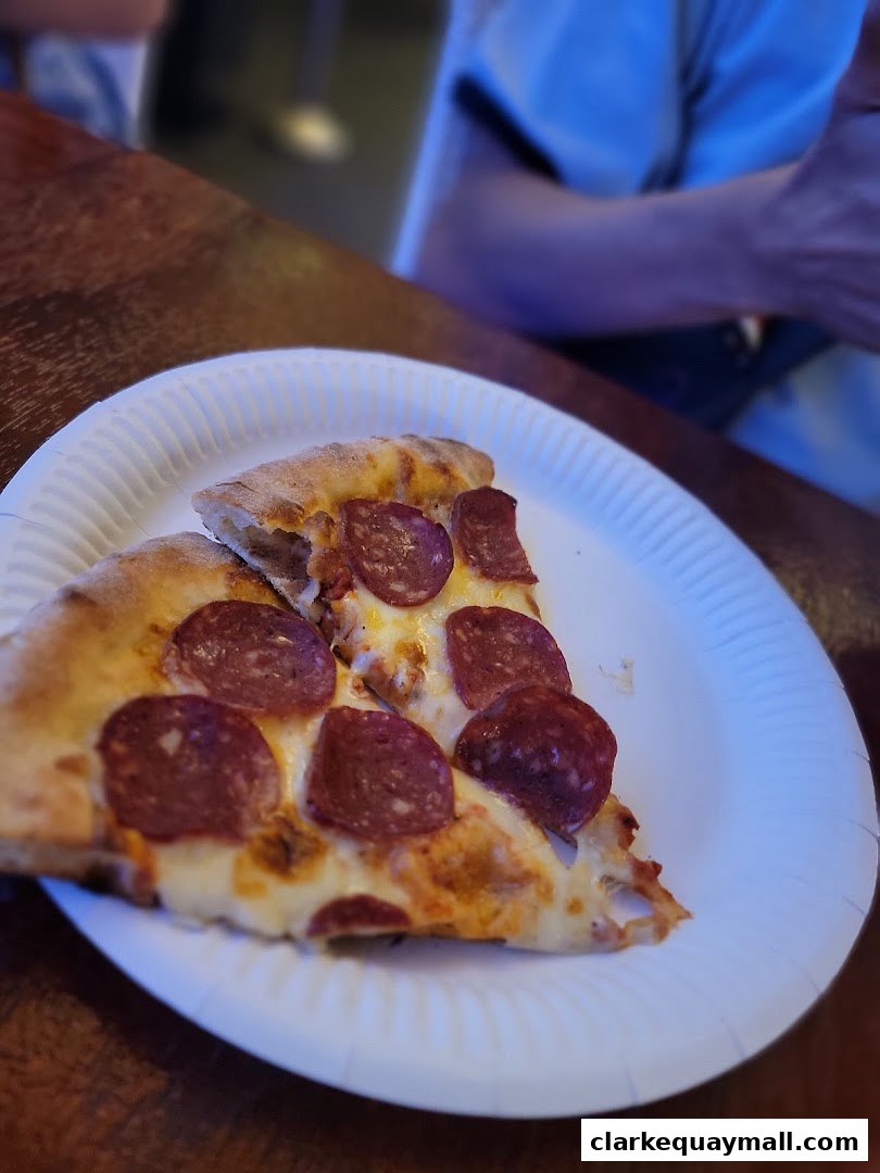 Two slices of pepperoni pizza on a white paper plate.