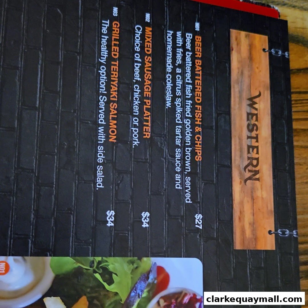 A menu featuring Western dishes like beer battered fish and chips, sausage platters, and salmon.