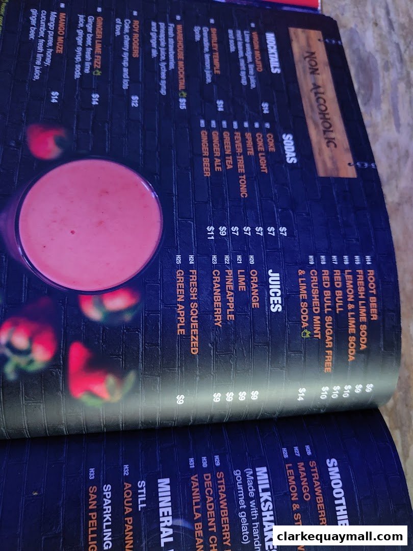 A menu from Warehouse Bar Singapore featuring mocktails, sodas, juices, smoothies, and milkshakes.