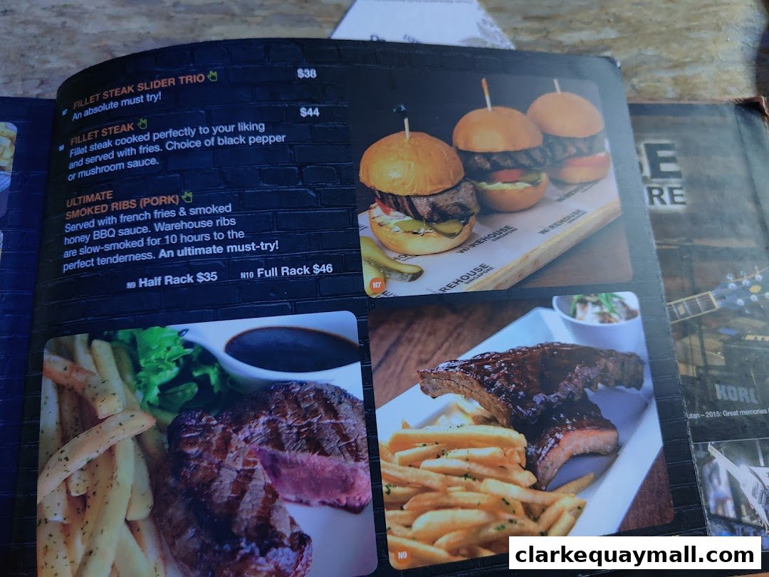 A menu featuring steak, sliders, and ribs with accompanying fries and sauces.