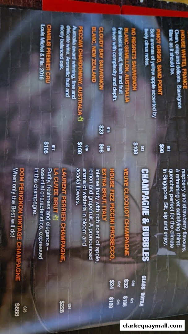 A menu page featuring a selection of wines and champagnes with descriptions and prices.