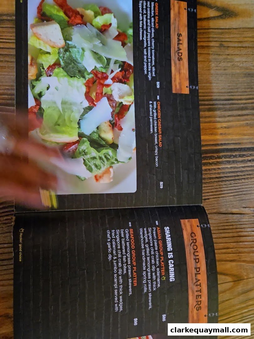 A menu featuring salads and group platters with enticing descriptions and prices.