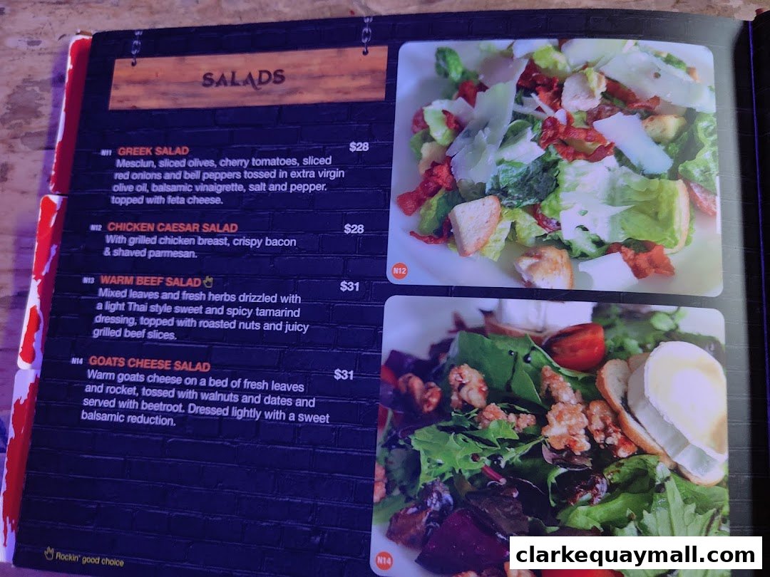 A menu page featuring various salads with accompanying images and descriptions.