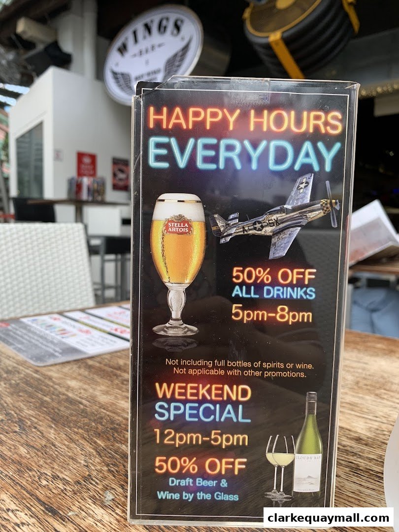 A sign advertising happy hour and weekend specials at Wings Bar & Grill.
