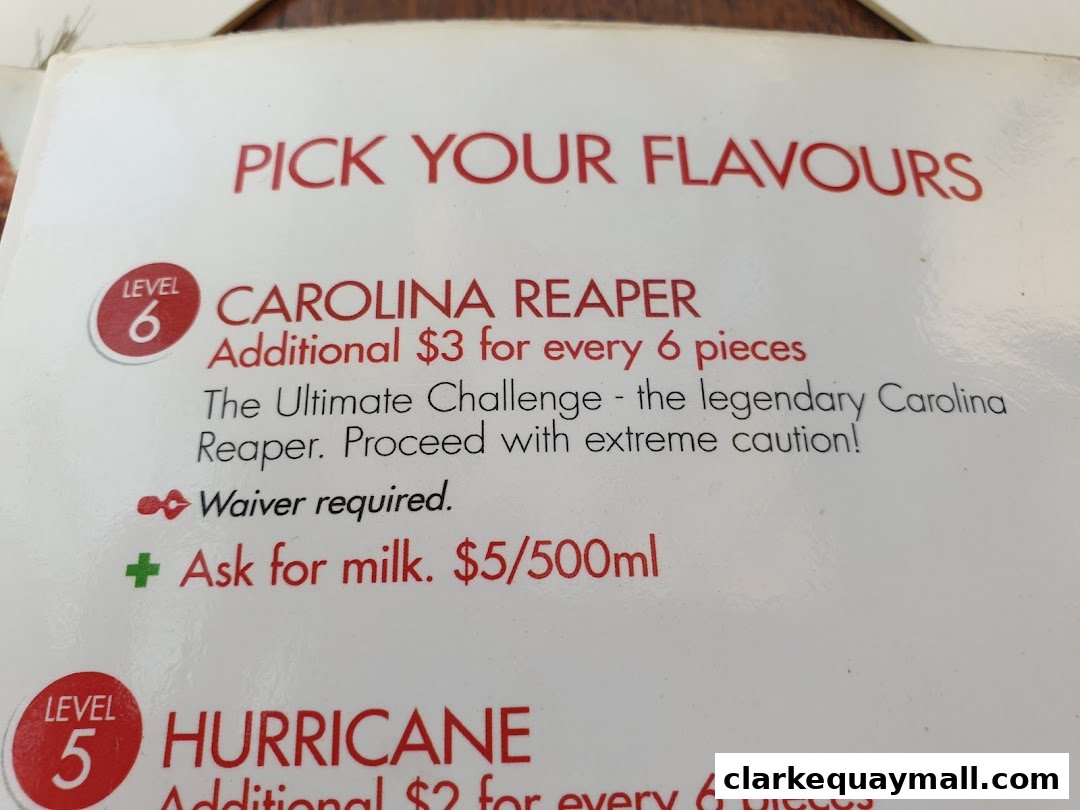 A menu section showing spicy chicken wing flavors with heat levels and descriptions.