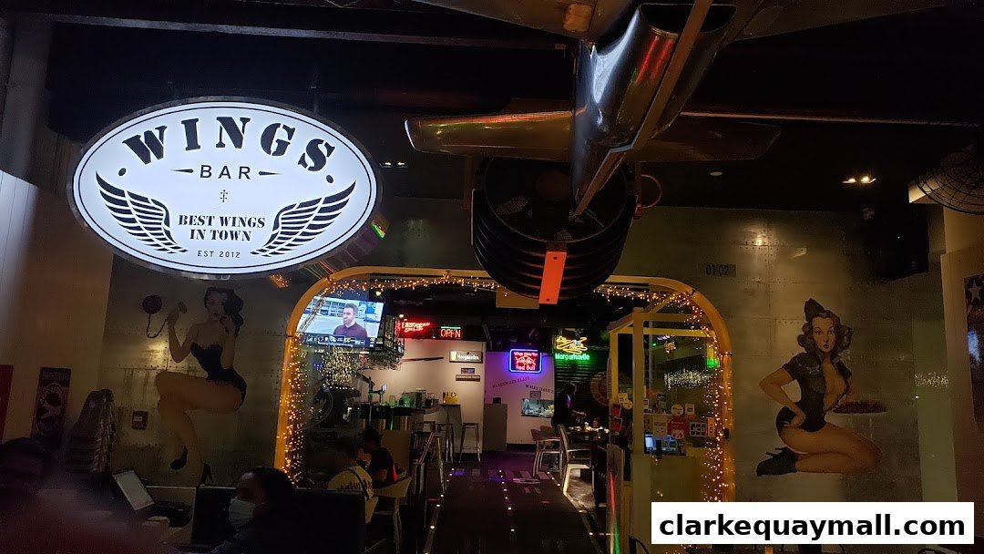 The entrance to Wings Bar & Grill, featuring a prominent sign and aviation-themed decor.