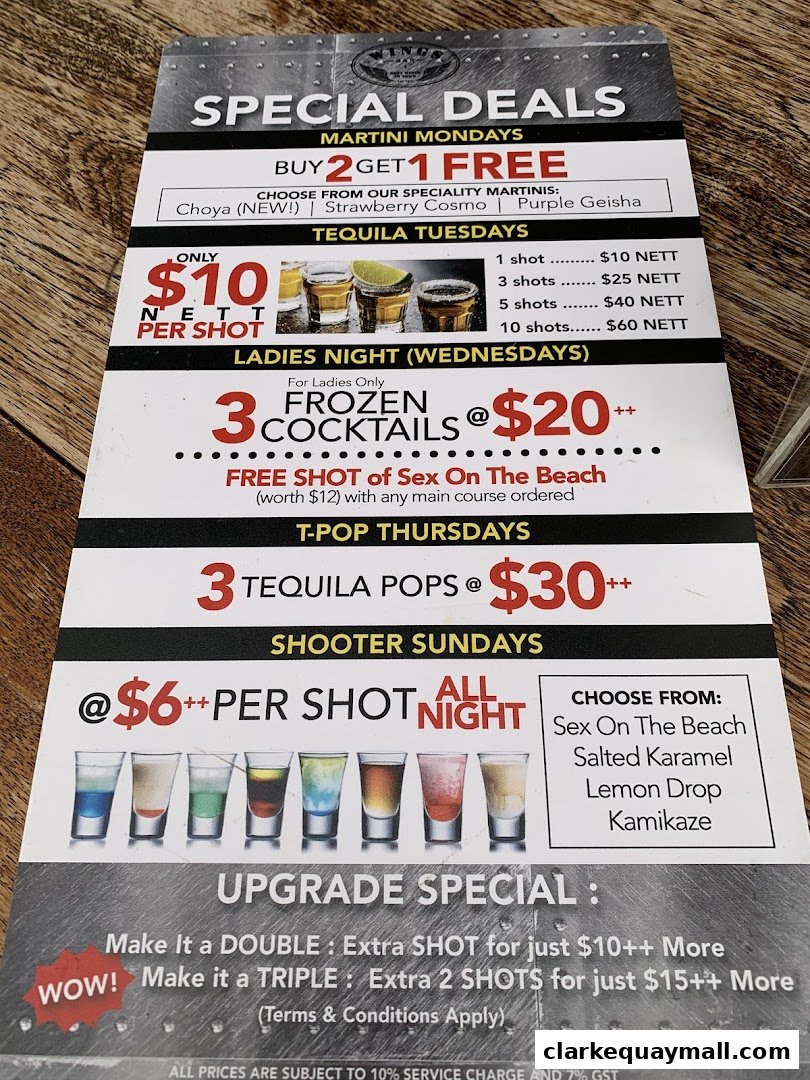 A promotional flyer detailing daily drink specials and upgrade offers at Wings Bar & Grill.
