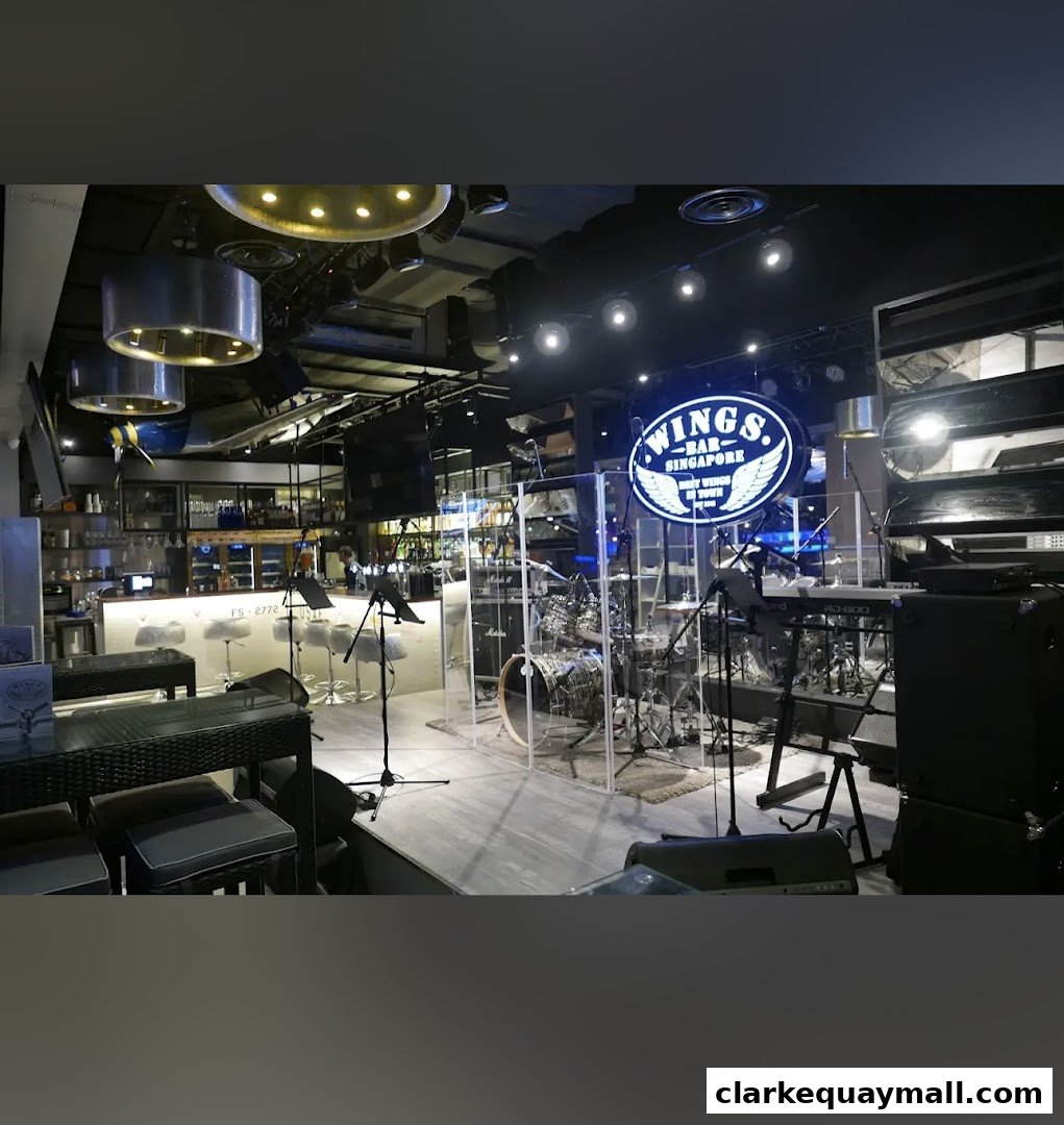 Interior of Wings Bar & Grill featuring a bar, seating, and a drum set.