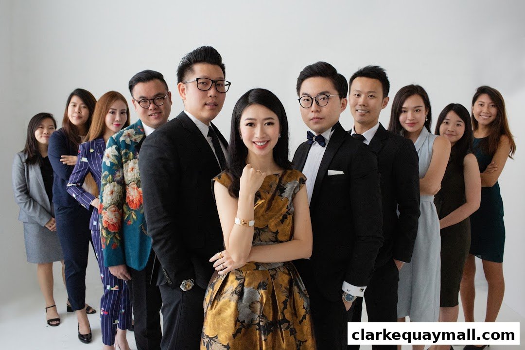 A diverse team of professionals posing for a group photo in formal attire.