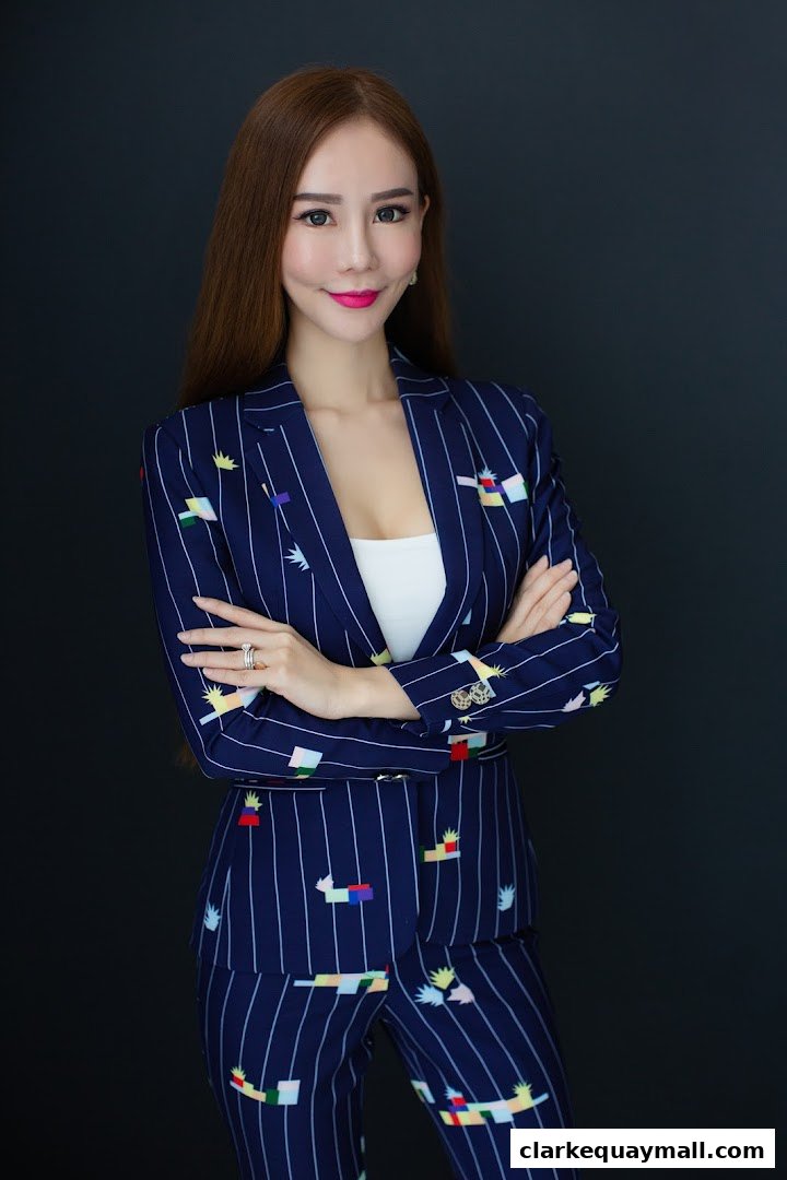 A professional woman in a stylish pinstripe suit with colorful abstract patterns.