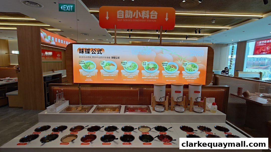 A self-service condiment station at XiaoYanZi Tomato Hot Pot with various sauces and toppings.