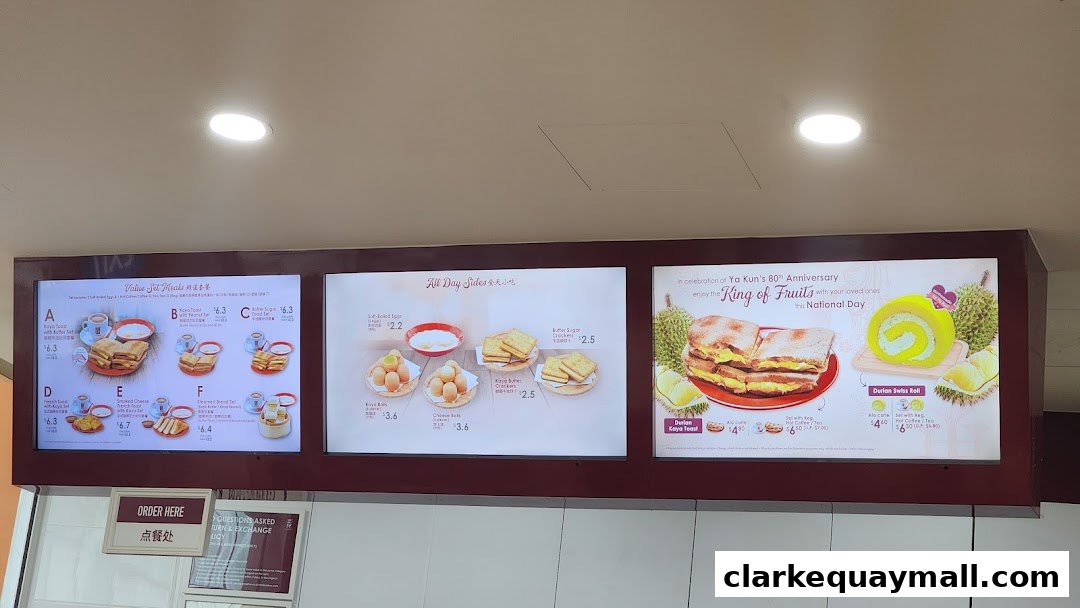 A menu board displaying various set meals, all-day sides, and special durian-themed items.