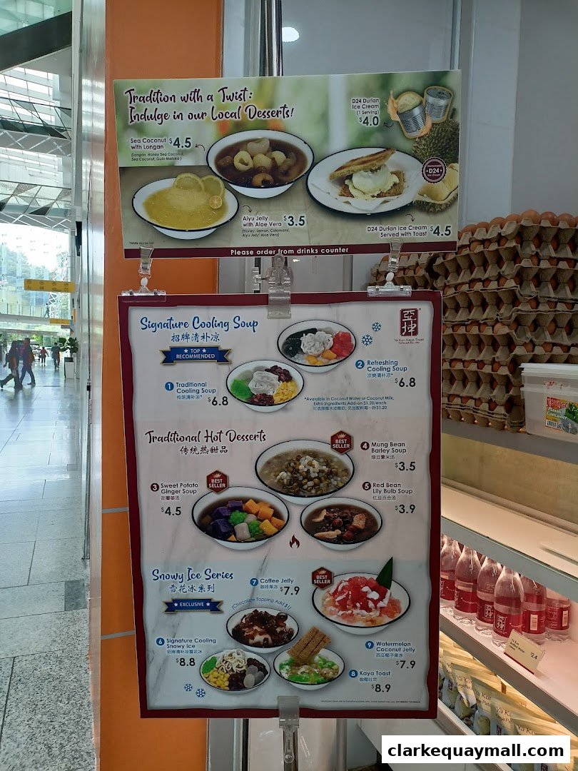 A menu board showcasing traditional desserts and cooling soups from Ya Kun Kaya Toast.
