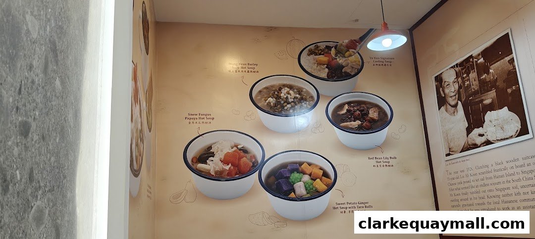 A wall display at Ya Kun Kaya Toast featuring various hot soups and a historical photo.