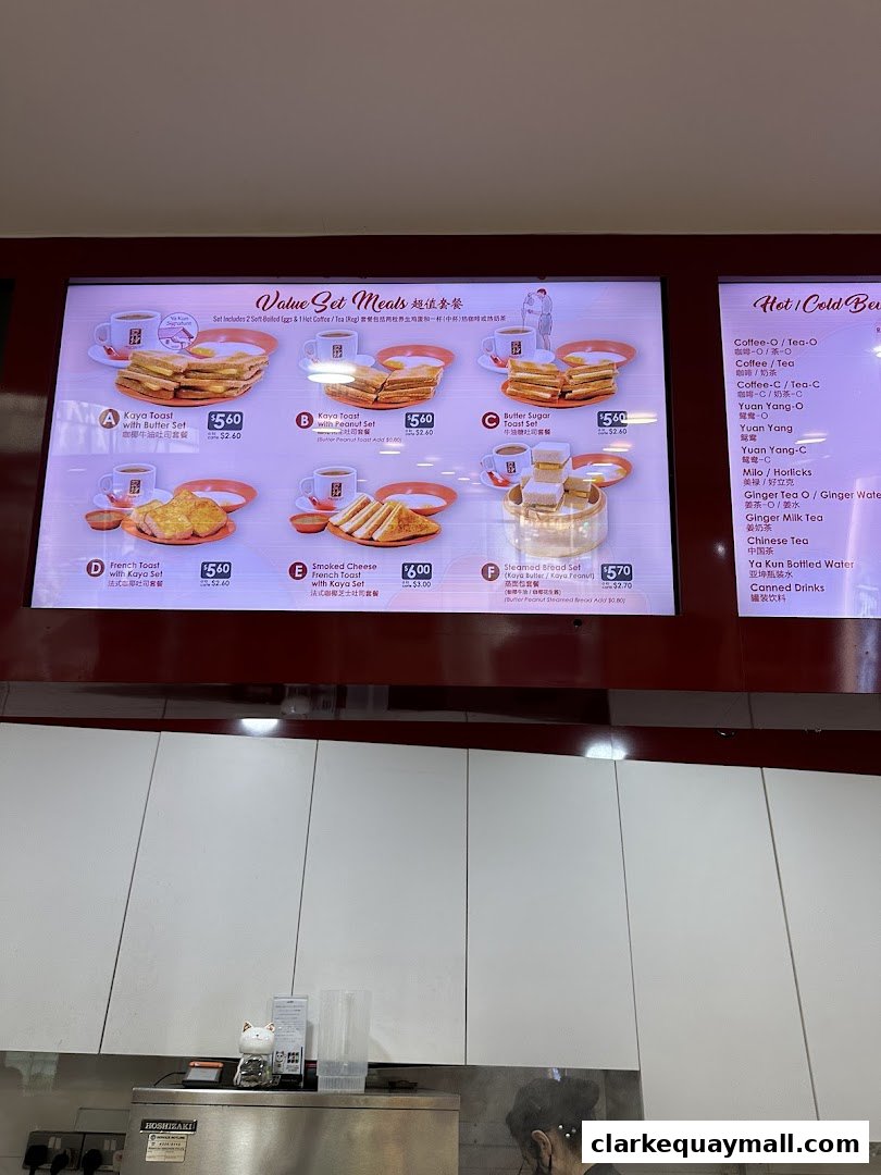 A digital menu board displaying various set meals and beverages at Ya Kun Kaya Toast.