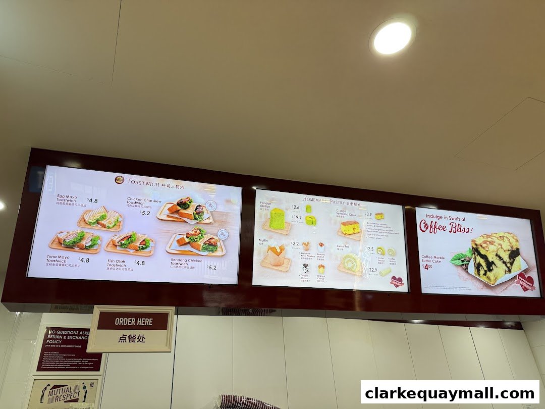 A menu board displaying various toast sandwiches, homemade pastries, and coffee drinks.