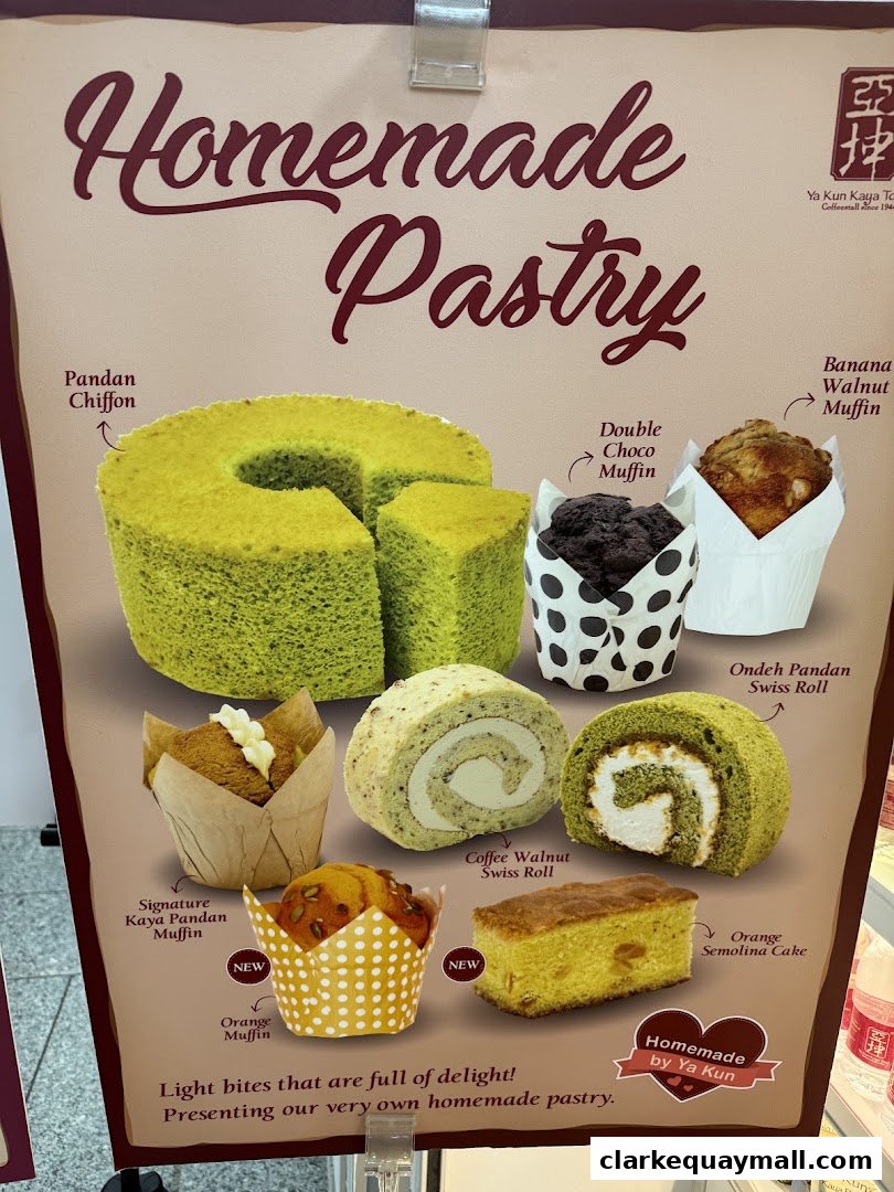 A display board showcasing various homemade pastries from Ya Kun Kaya Toast.