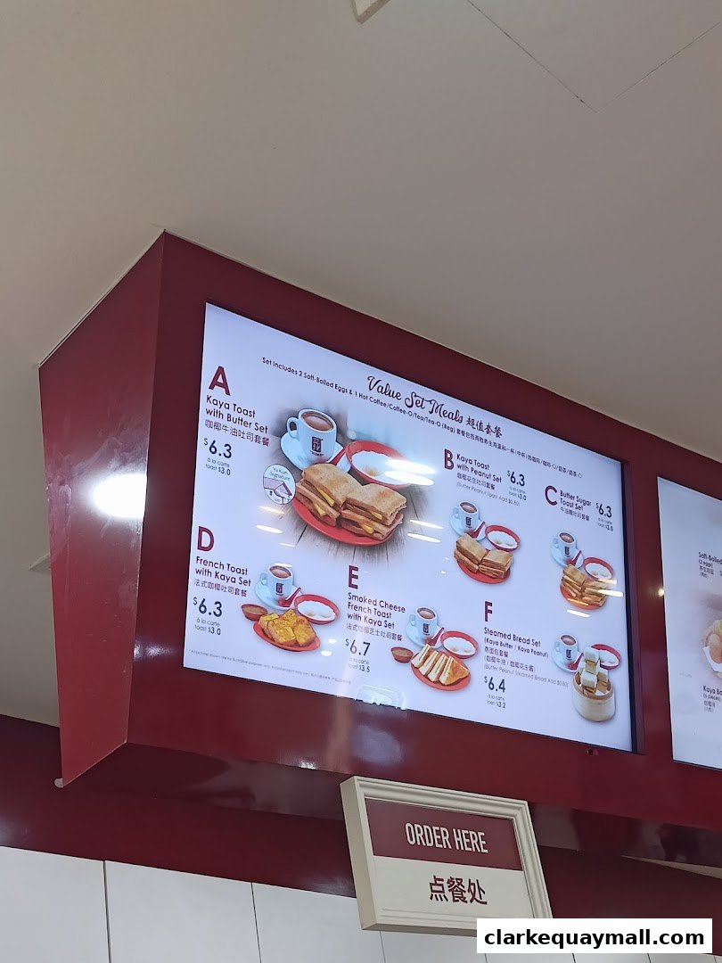 A digital menu board displaying various value set meals with images and prices.