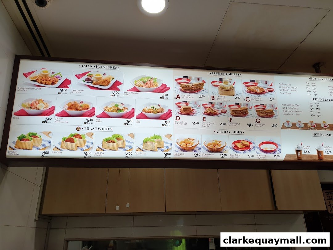 A brightly lit menu board displaying various food and beverage options from Ya Kun Kaya Toast.