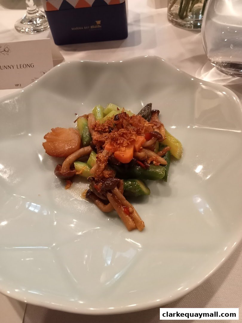 A close-up of a beautifully presented dish with vegetables and mushrooms on a white plate.
