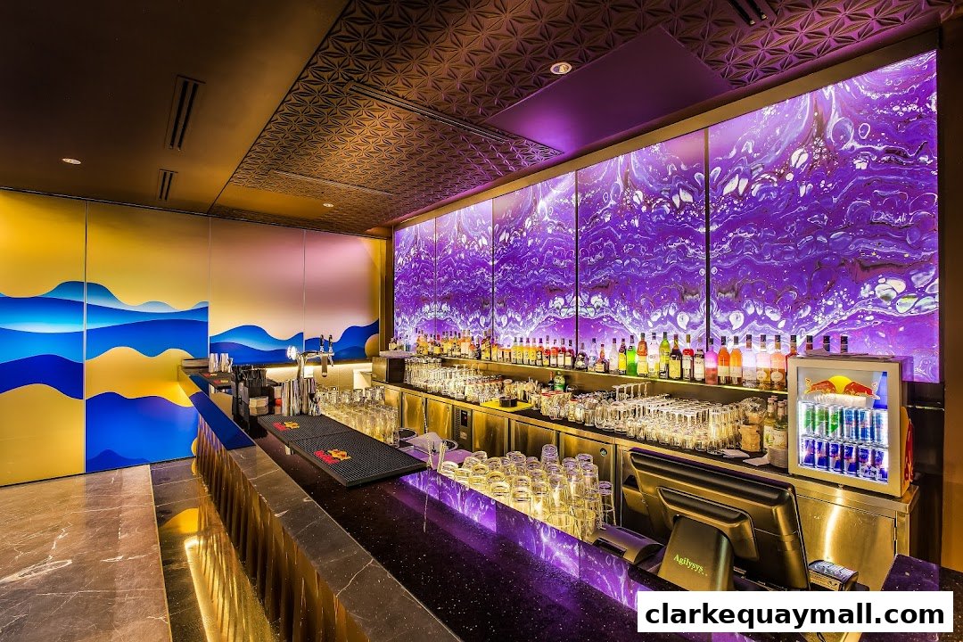 A stylish bar interior with a long counter, illuminated purple backdrop, and a wide selection of bottles.