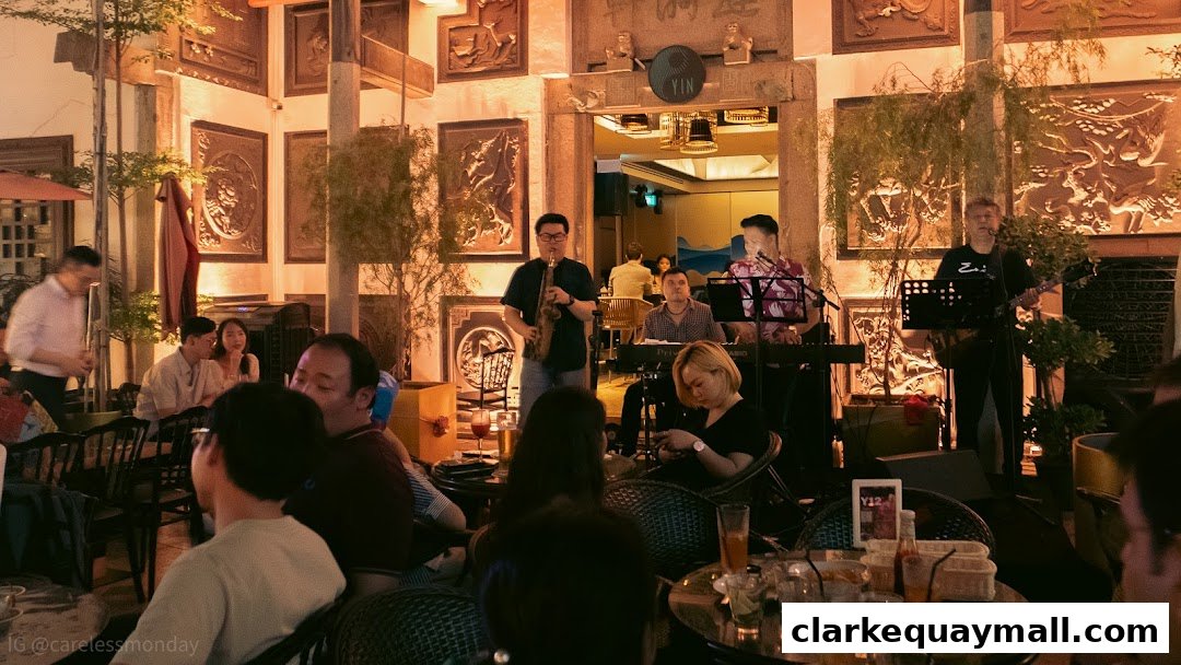 A live band performs at Yin Bar Singapore, with patrons seated at tables enjoying the music and ambiance.
