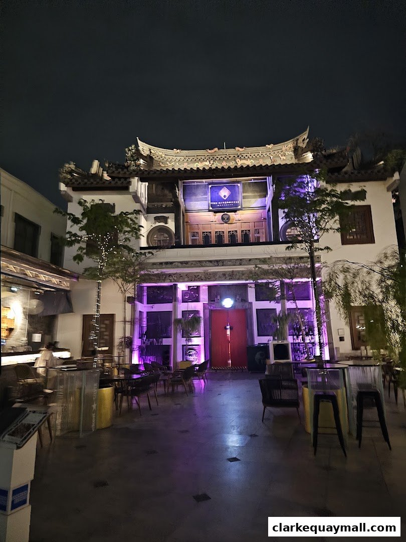 Exterior view of Yin Bar Singapore at night, featuring traditional architecture and outdoor seating.