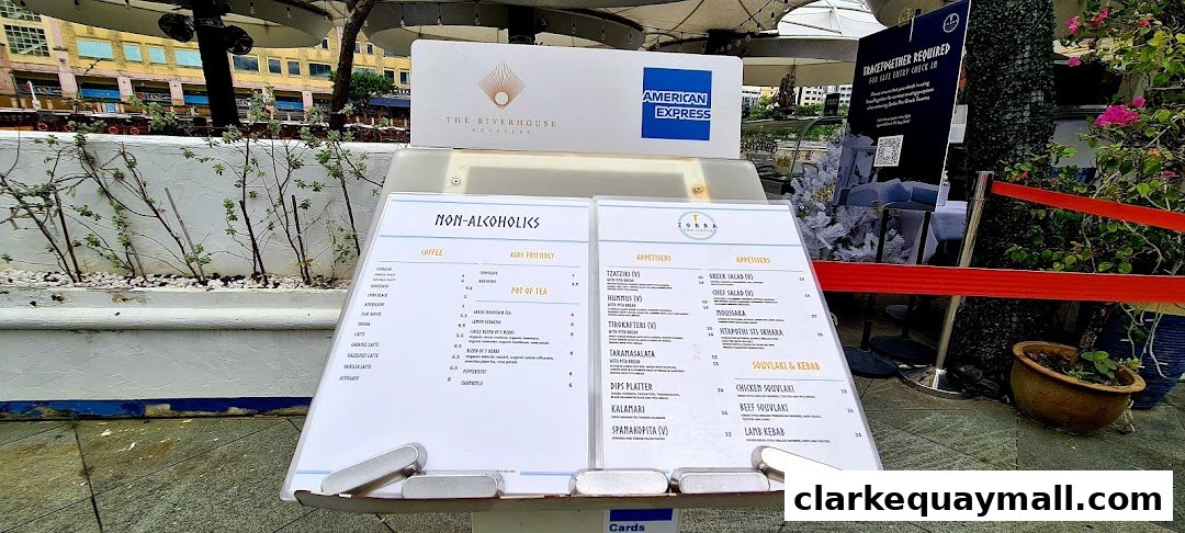 A menu stand displays a list of non-alcoholic drinks and appetizers for Zorba The Greek Taverna.