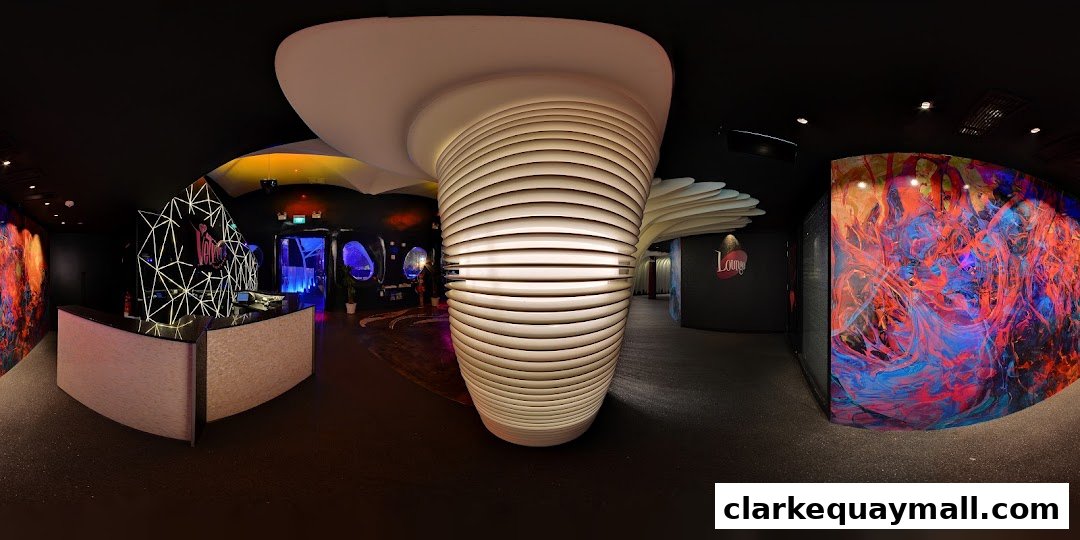 Interior view of Zouk Singapore with a reception desk and vibrant artwork.