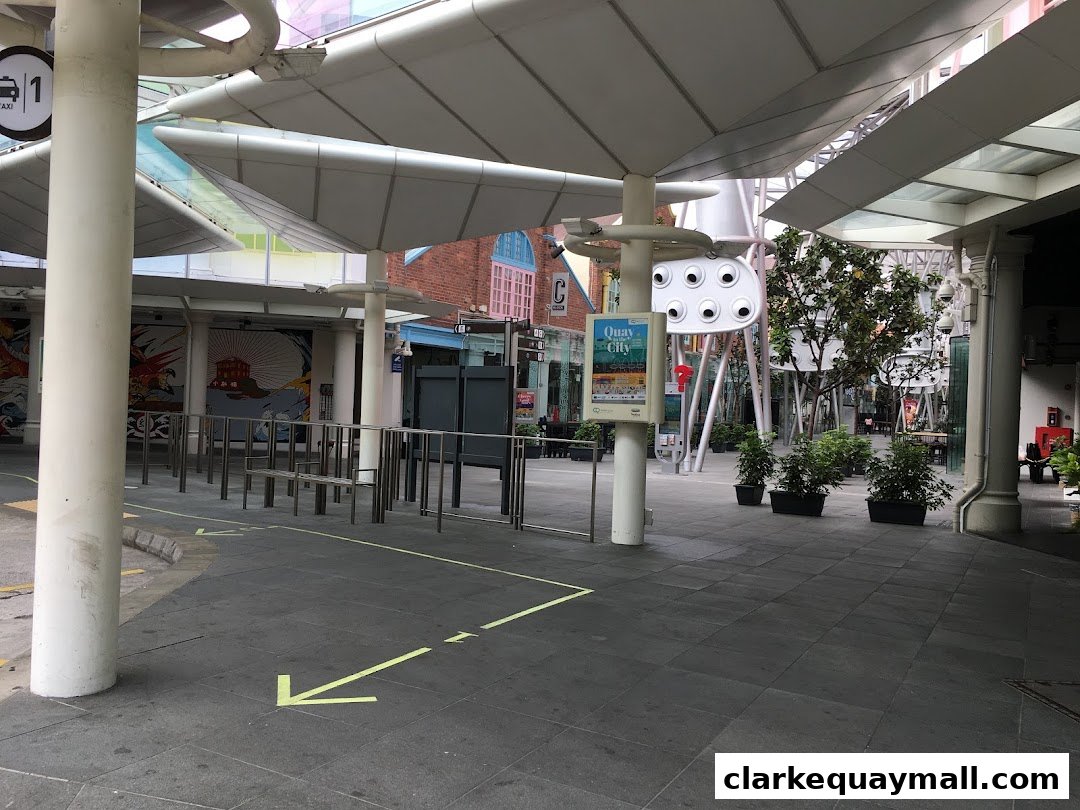 An outdoor walkway with a taxi stand sign and decorative elements.