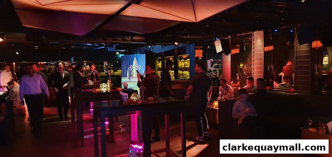 People mingling and enjoying themselves in a dimly lit, stylish lounge with modern decor.