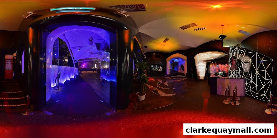 Interior view of a modern nightclub with vibrant lighting and unique architectural features.