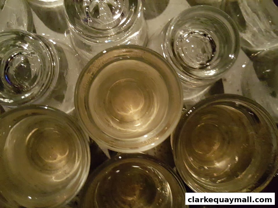 A close-up overhead view of several empty shot glasses arranged on a surface.
