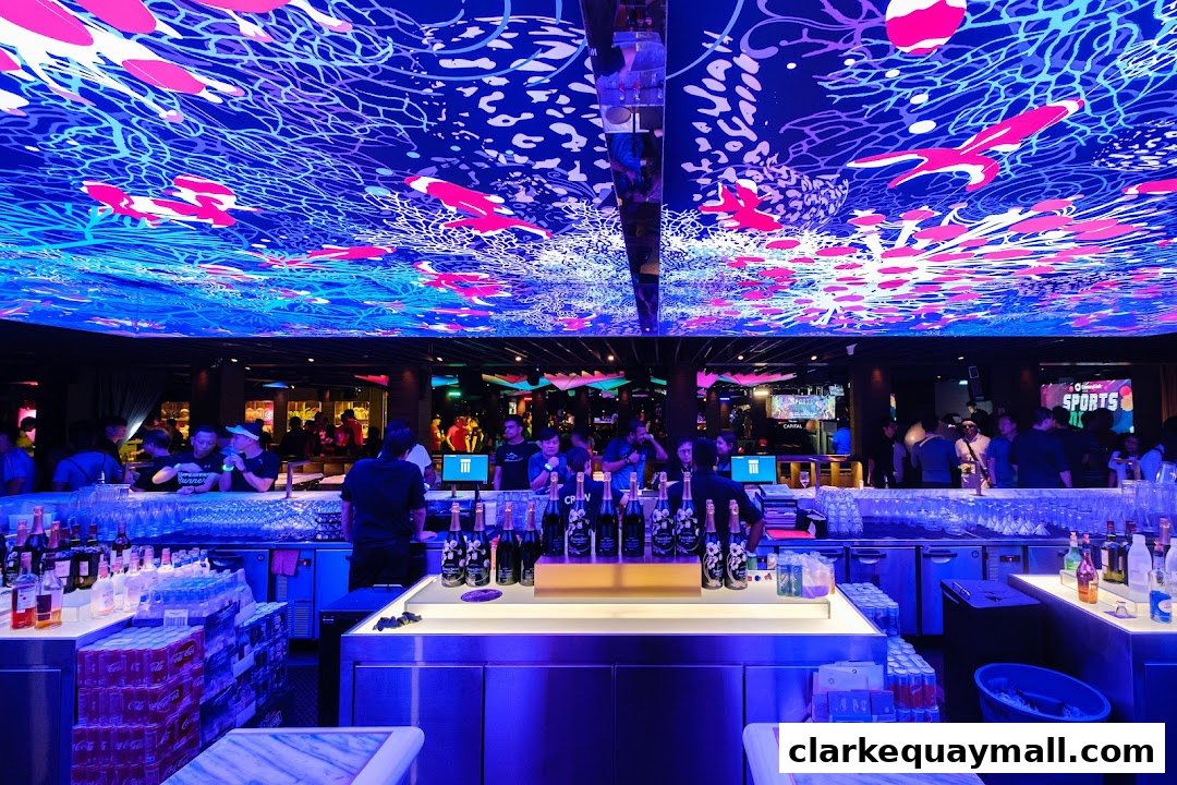 A vibrant bar interior with a colorful, illuminated ceiling and patrons at the bar.