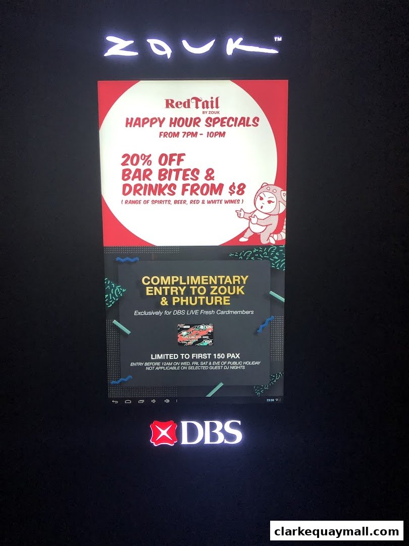 A digital display advertises happy hour specials and complimentary entry for DBS cardmembers at Zouk.